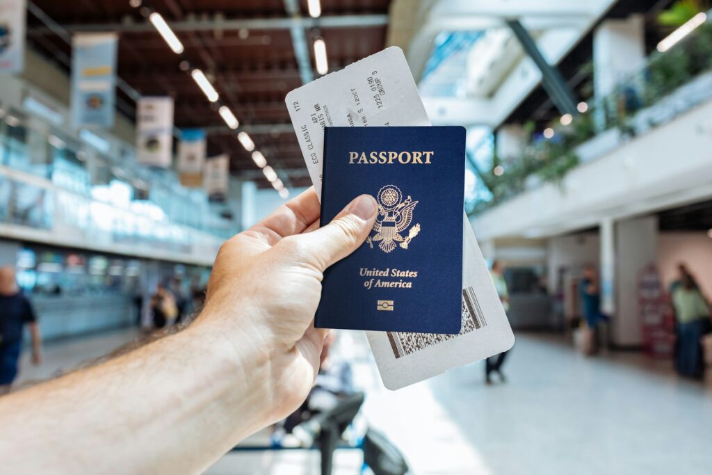 hand holding a passport in the airport