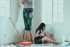 Family repairs. Couple at home. Woman in a overalls