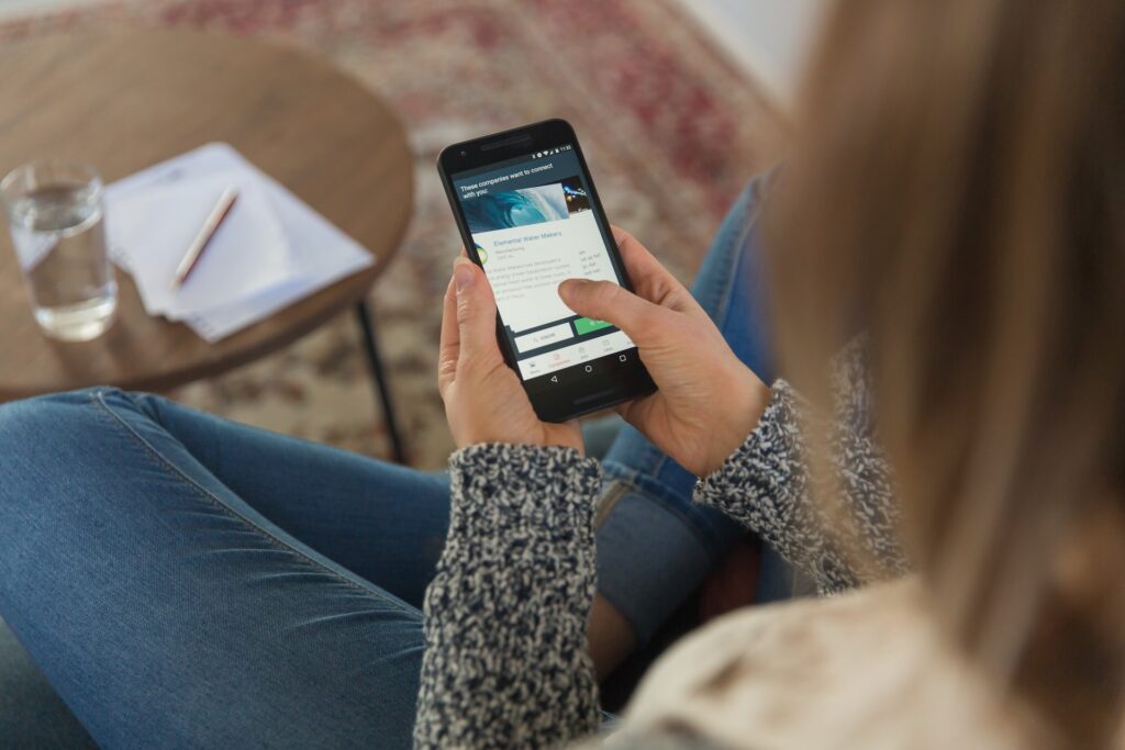 Woman with a iphone connecting Portugal sim card
